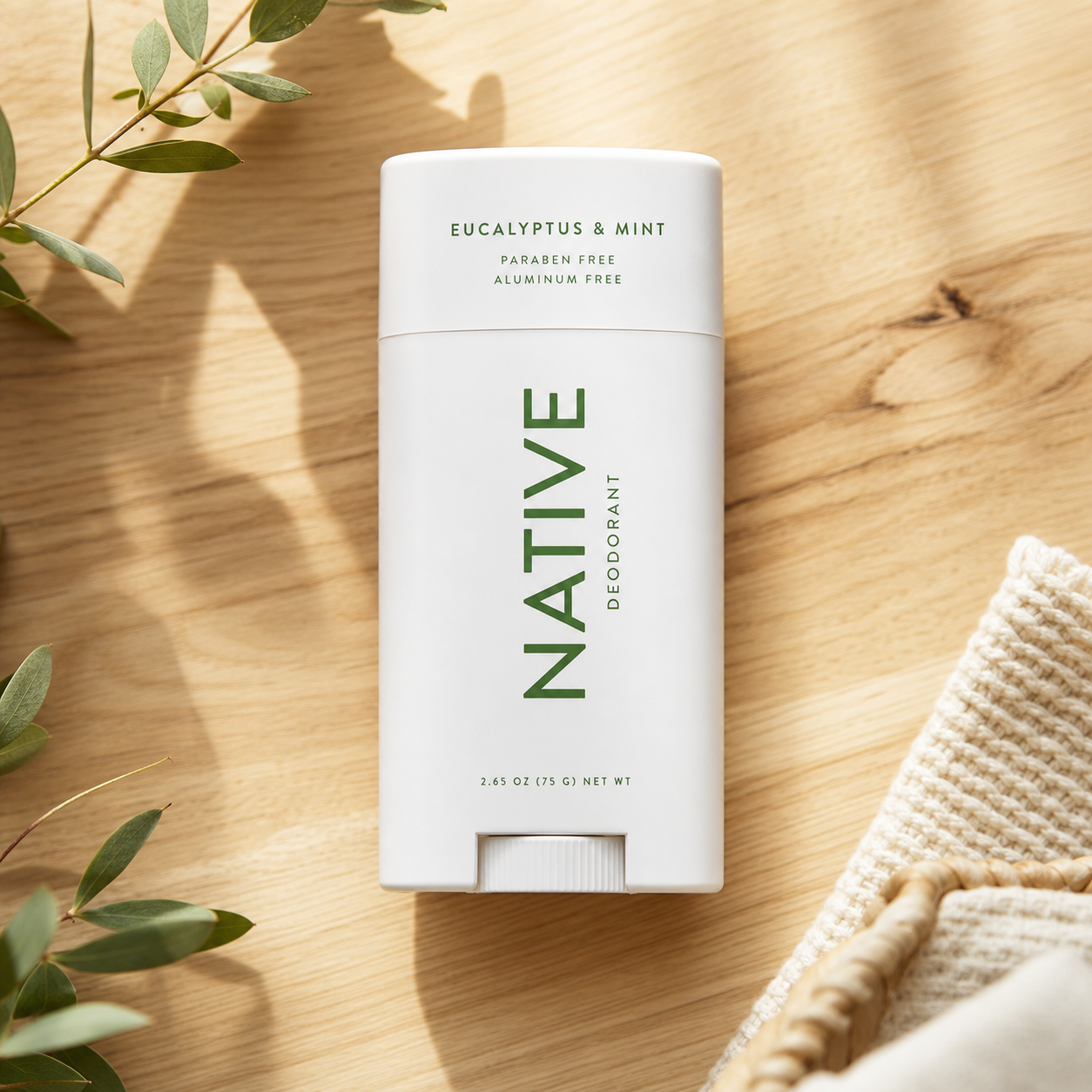 Native deodorant on a light wooden surface