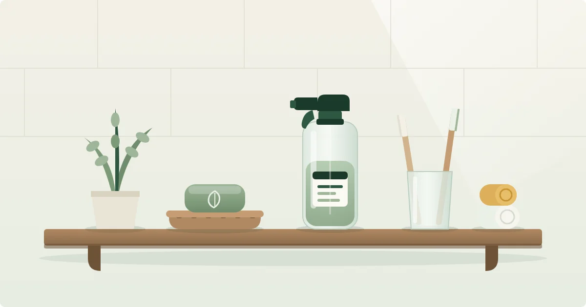 Illustration of a bathroom shelf with a shampoo bar on a wooden dish, a refillable glass spray bottle, and bamboo toothbrushes in a glass cup